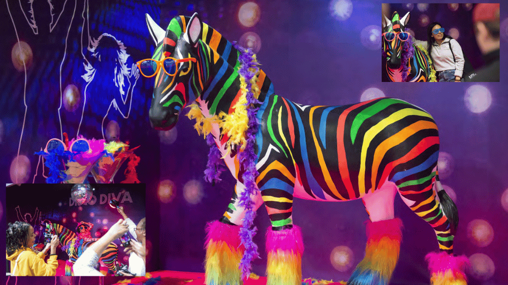 A lifesize model of a unicorn with rainbow stripes, wearing sunglasses